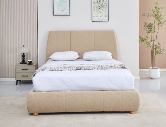 Beige upholstered bed with white bedding in a bedroom setting.