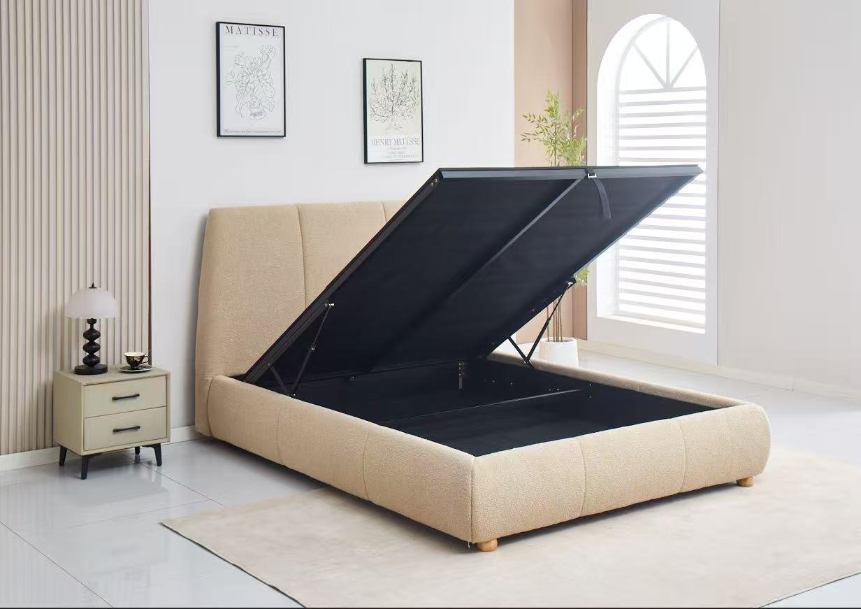 Beige upholstered bed with open storage compartment in a bedroom setting.