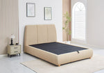 Beige upholstered bed in a modern bedroom setting with a nightstand and decor.
