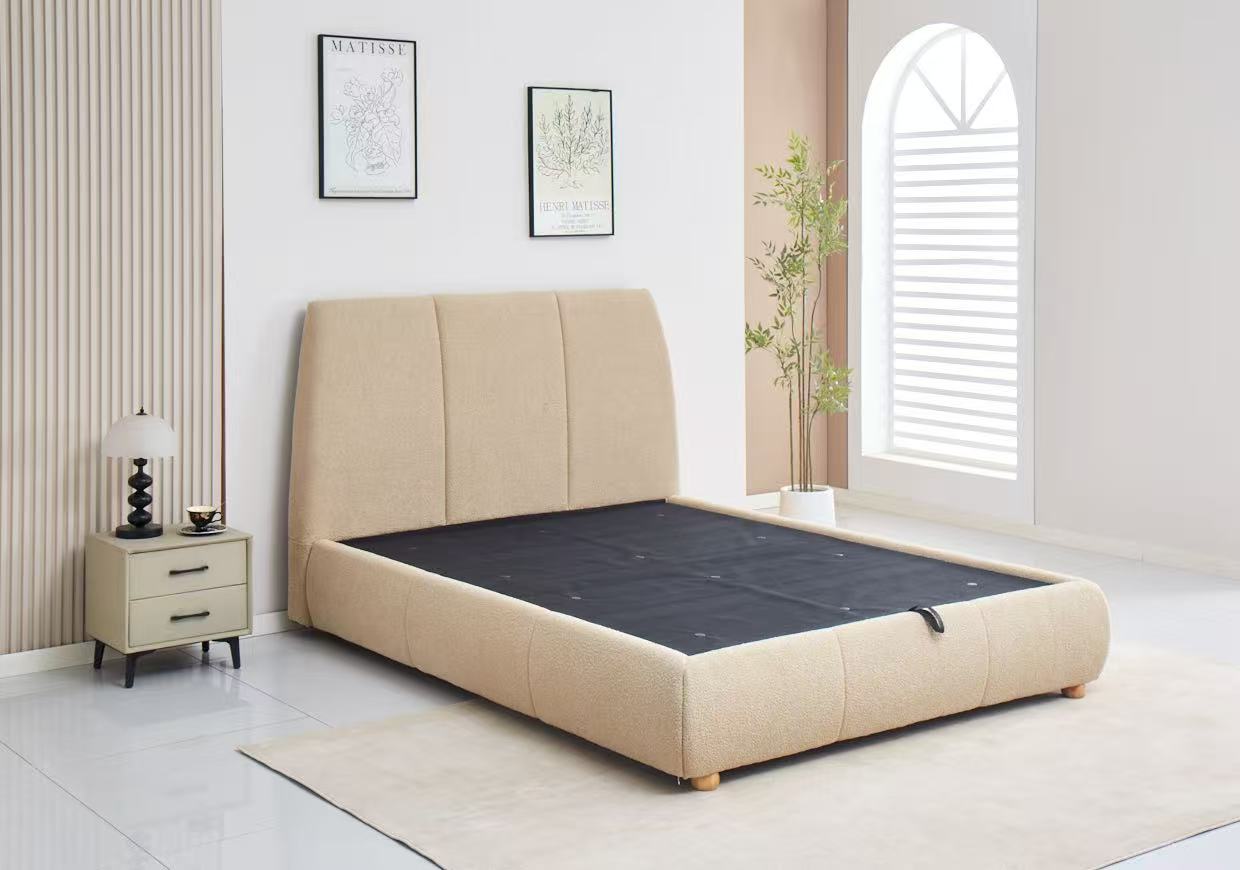 Beige upholstered bed in a modern bedroom setting with a nightstand and decor.