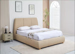 Beige upholstered bed in a modern bedroom with white walls and decor.
